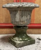 A terracotta campana garden urn on an associated waisted base with square plinth (a/f). 61cm by