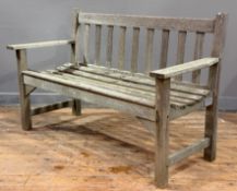 A vintage weathered Burmese teak slatted garden bench. 78cm by 121cm by 49cm (en suite with the