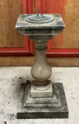 A carved and composition stone garden sundial, the square top with a verdigris patinated dial (