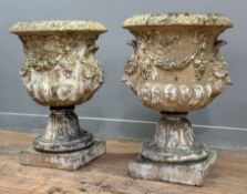 A pair of painted stoneware garden urns, the urns of campana form, moulded with floral swags and