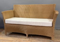 A modern wicker conservatory sofa, with loose-cushioned seat. 80cm by 147cm by 55cm.