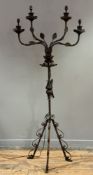 A rusted patinated metal ecclesiastical four-light tloor-standing candelabrum, cast with leaves on a