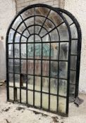 A single large cast-iron framed arched garden mirror of astragalled window form (a/f).186cm by