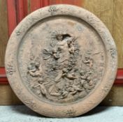 A terracotta wall-handing roundel, moulded in relief with a figure of Flora surrounded by putti,