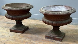 A pair of ceramic gardnen urns with terracotta finish, of compressed campana form, with bands of