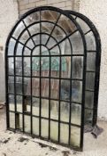 A single large cast-iron framed arched garden mirror of astragalled window form (a/f). 186cm by