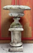 A large painted stoneware centrepiece campana garden urn, standing on a (possibly associated) fluted