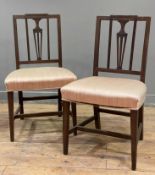 A pair of Edwardian mahogany side chairs, carved urn splat back over soft pink upholstered seat,