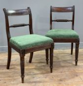 A pair of William IV mahogany side chairs, carved top rail over rope twist horizontal splat, green