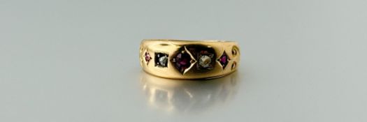 An Edwardian 15ct gold ring with star set facet cut ruby approximately 0.07ct flanked by a rose cut