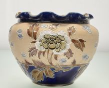 A Royal Doulton & Slaters pottery jardiniere decorated in the typical brown and blue glaze with