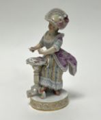 A late 19thc Meissen figure of a card player, after an original by Acier, the lady dressed in an