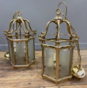 A pair of modern brass hall lanterns, of hexagonal form with frosted glass panels and three light