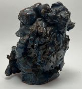 An abstract studio pottery centerpiece of naturalistic form, decorated with mottled turquoise and