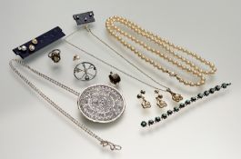 A collection of silver and gilt metal jewellery to include a Mexican silver disk pendant brooch on