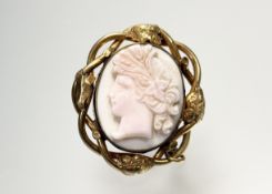 A late 19thc yellow metal framed twist vine leaf decorated shell cared portrait cameo after the
