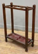 An Edwardian oak stick stand, three dividers to top over later drip tray, raised on shaped square