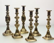 A collection of three pairs of brass candlesticks, one pair with marked 