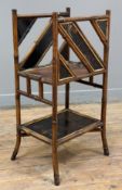 An early 20th century bamboo and lacquer magazine stand, decorative panels featuring birds and