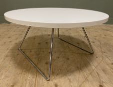 A modern circular coffee table by Boss Design, white hardwood top raised on chrome steel sled