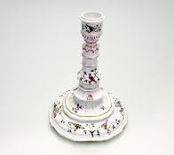 A 20thc Meissen Candlestick holder, of moudled knoped form with hand-painted floral sprays with