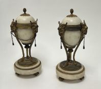 A pair of French Neo-Classical style marble and gilt metal casolettes, decorated with ram heads