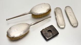 A Birmingham silver-backed pair of hair brushes with engine turned decoration and a pair of matching
