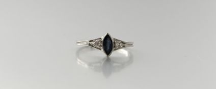 A platinum ring set marquise faceted sapphire approximately 0.15ct flanked by a diamond