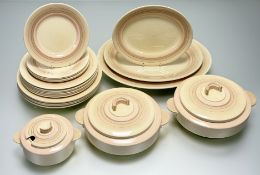A Royal Doulton Art Deco pale pink and cream part dinner service, a graduated trio of twin handled
