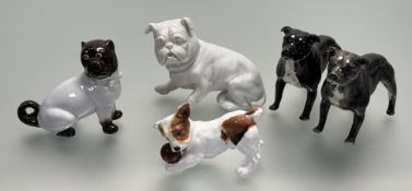 A collection of dog figurines comprising, a bisque porcelain bulldog figure, a Royal Doulton Jack