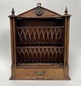 A wall-hanging wooden letter rack, two tiers of angled dividers above a single long drawer with