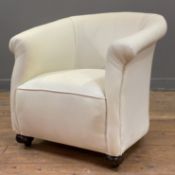 An Edwardian tub chair, curved back and rolled arms, upholstered in white fabric with green slip-