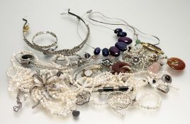 A large collection of costume jewellery to include a paste set tiara, a three-strand Chinese