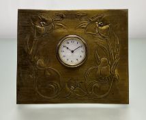 An Art Nouveau German brass mantel clock of square form with embossed stylized foliate design,