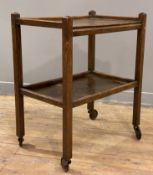 A 1930s oak two-tier tea trolley, ledge top raised on four square supports terminating on castors: