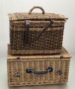 A rectangular wicker hamper with brown leather straps and handle to front (h-26cm l-50cm),