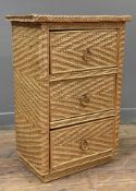 A mid-century wicker and pine chest of drawers, woven rattan fitted with three drawers on a plinth