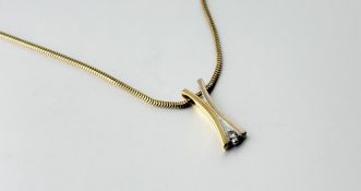 An 18ct yellow and white gold X shaped white enamel pendant necklace set with a brilliant circular