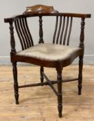 An Edwardian mahogany corner chair, inlaid floral patera over spindle sides, upholstered seat raised
