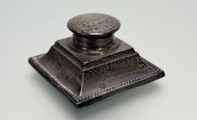 A George V London silver capstan-style desk inkstand with hinged top and original glass liner on
