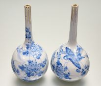 A pair of 20thc Japanese blue and white water dropper vases, with hand-painted bird and