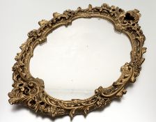 A Reproduction in the Chippendale style ornate carved rocco-style gilt painted carved frame with