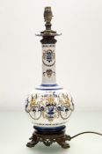 An Italian Majolica style bottle vase converted table lamp, with hand-painted scolling swags and
