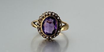 A 9ct gold ring set oval facet cut amethyst approximately 2ct within a rope pattern border a/f N/O
