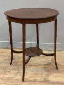 An Edwardian mahogany lamp table, circular moulded top raised on square supports over low-level