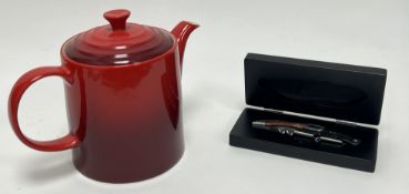 A Le Creuset medium teapot in 'Cerise', marked verso (h. 18cm), together with a Le Creuset 2-step