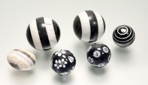 A collection of decorative balls comprising, a pair of striped black and white carpet balls (a/f), a