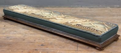 A 19th century mahogany footstool, upholstered top with needlepoint fabric featuring leaf and