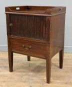 A George III mahogany bedside cabinet, tray top over tambour door cupboard and drawer, raised on