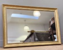 A rectangular mantle mirror, in a gilt frame with grey painted slip, with mirror panel to centre. (